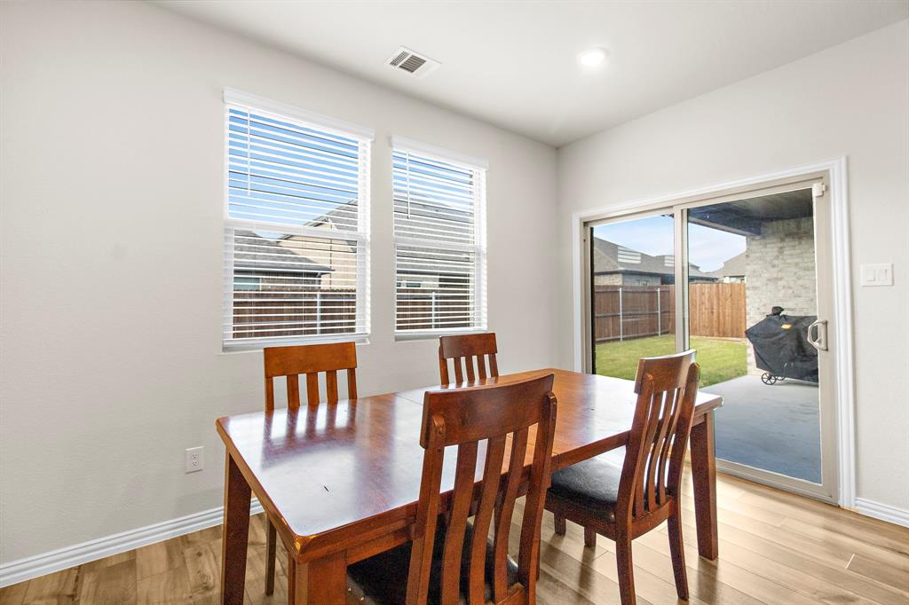 1211 Sweetleaf Street Melissa, TX 75454 - Photo 29 of 37 a view of a dining room with furniture and wooden floor