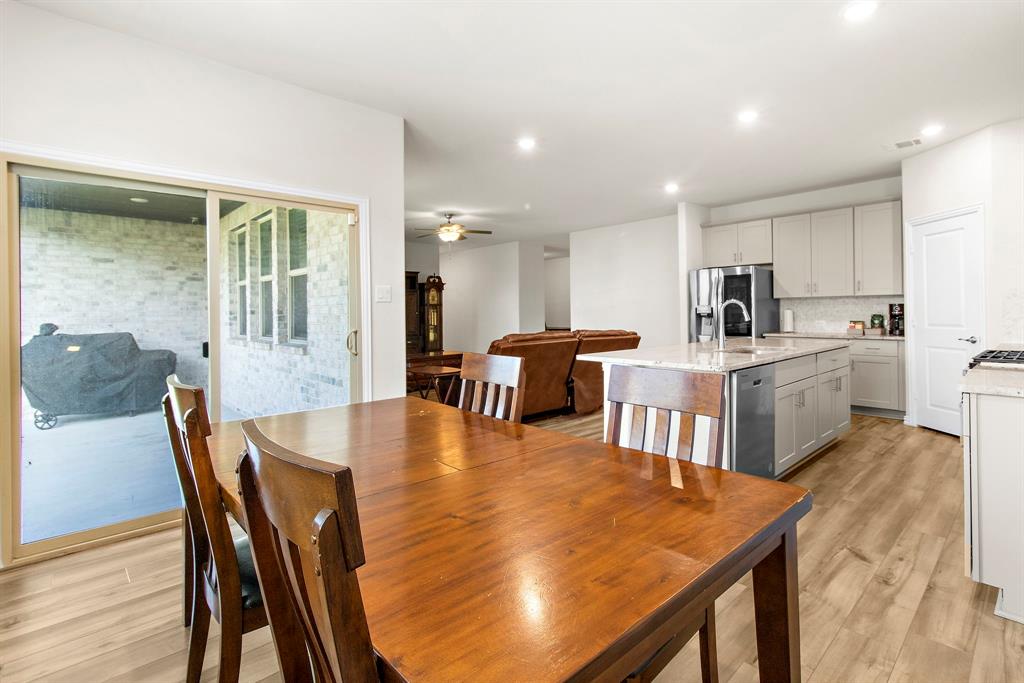 1211 Sweetleaf Street Melissa, TX 75454 - Photo 30 of 37 a dining room with furniture and wooden floor