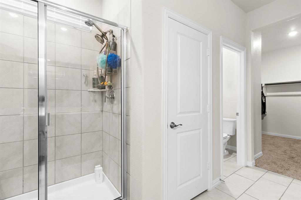 1211 Sweetleaf Street Melissa, TX 75454 - Photo 35 of 37 a bathroom with a shower and a glass door