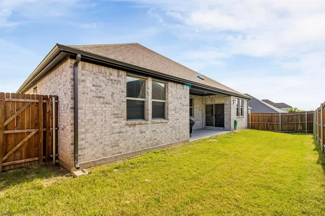 a backyard of a house with wooden fence