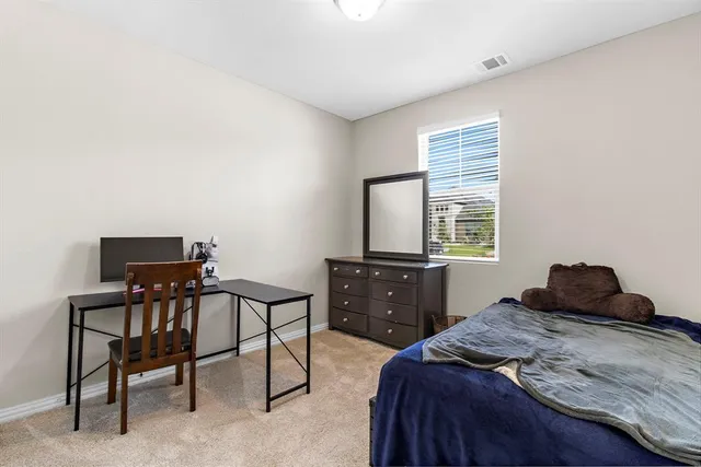 a bedroom with a bed and a tv on table