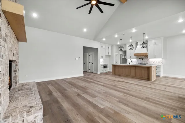 a view of empty room with fireplace and window