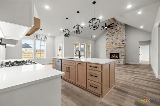 a view of an empty room with a window and fireplace