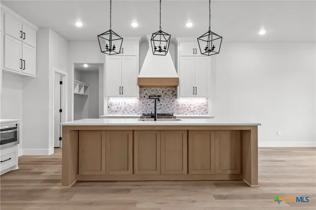 a stove top oven sitting inside of a kitchen