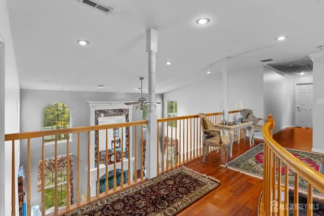 a view of a hallway with a dining table chairs and stairs