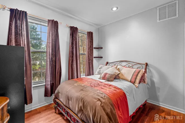 a bed sitting in a bedroom next to a window