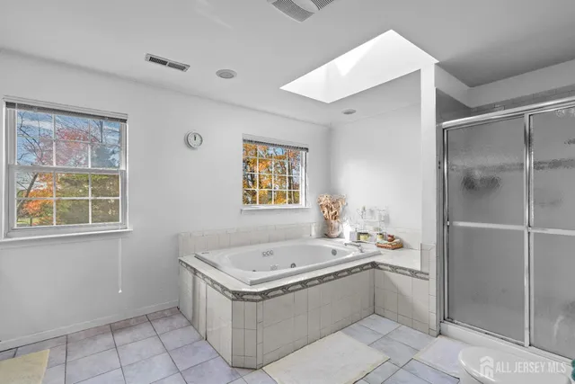 a bathroom with a bathtub sink and mirror