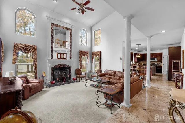 a view of a livingroom with workspace and a fireplace