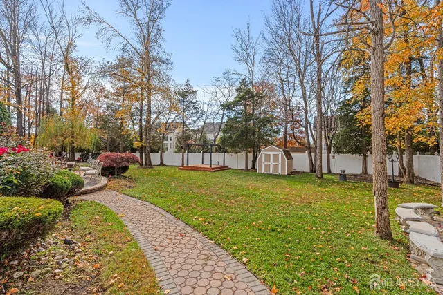 a backyard of a house with barbeque oven table and chairs