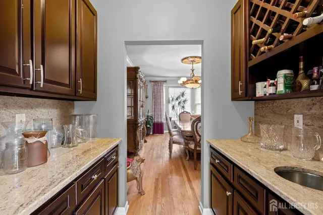 a kitchen with a sink and wooden floor