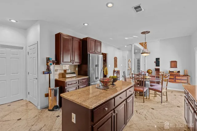 a kitchen with a sink refrigerator and cabinets