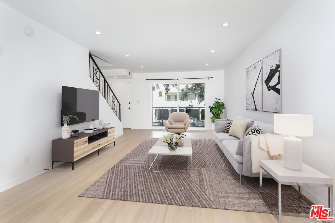 560 North Kings Road, Unit 2 West Hollywood, CA 90048 - Photo 1 of 12 a living room with furniture and a flat screen tv