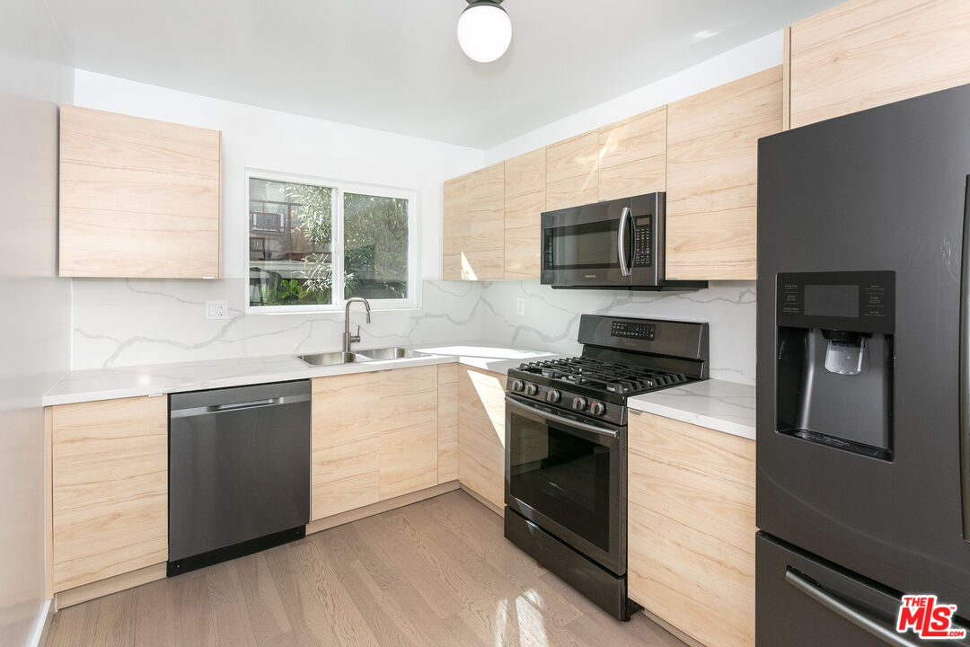 560 North Kings Road, Unit 2 West Hollywood, CA 90048 - Photo 2 of 12 a kitchen with a stove and a sink