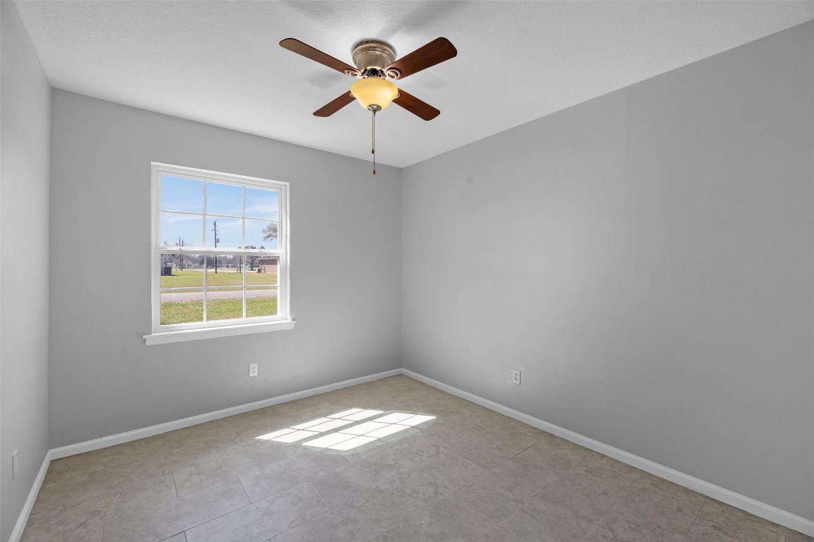 605 Helms Avenue Wharton, TX 77488 - Photo 25 of 45 Guest Bedroom #1 is a nice size as well. Brand new ceiling fans.