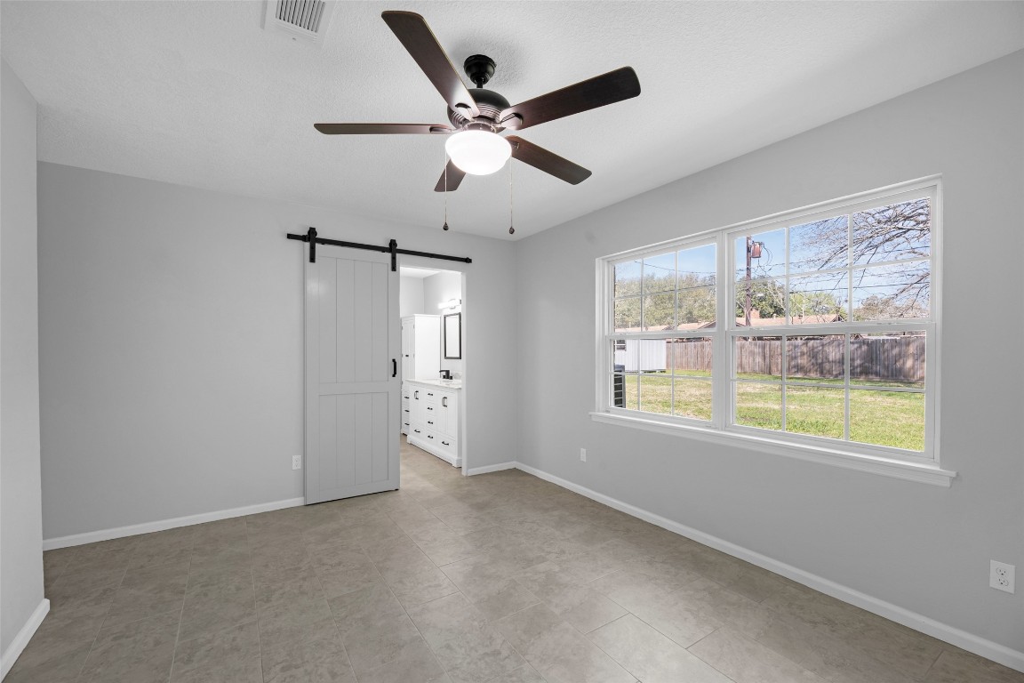 605 Helms Avenue Wharton, TX 77488 - Photo 29 of 45 Master en-suite with barn door, also has a view of the backyard.
