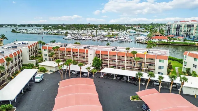 an aerial view of residential houses with outdoor space and boats