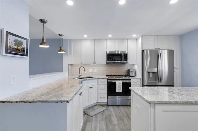 a bedroom with a bed painting on wall and a potted plant