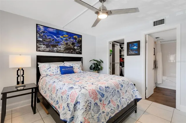 a spacious bedroom with a bed and a table in it