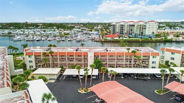 a bedroom with a bed and a flat tv screen next to a window