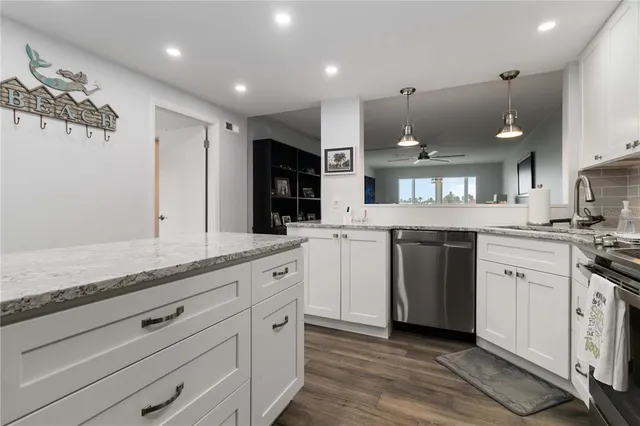 a view of a hallway with wooden floor and a living room