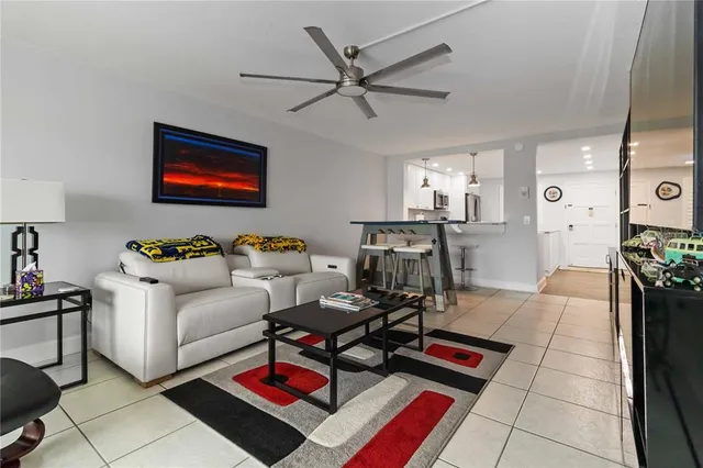 a room with furniture a rug kitchen view and a window