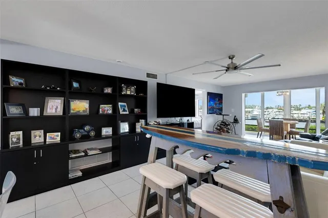 a kitchen with a dining table chairs and a refrigerator