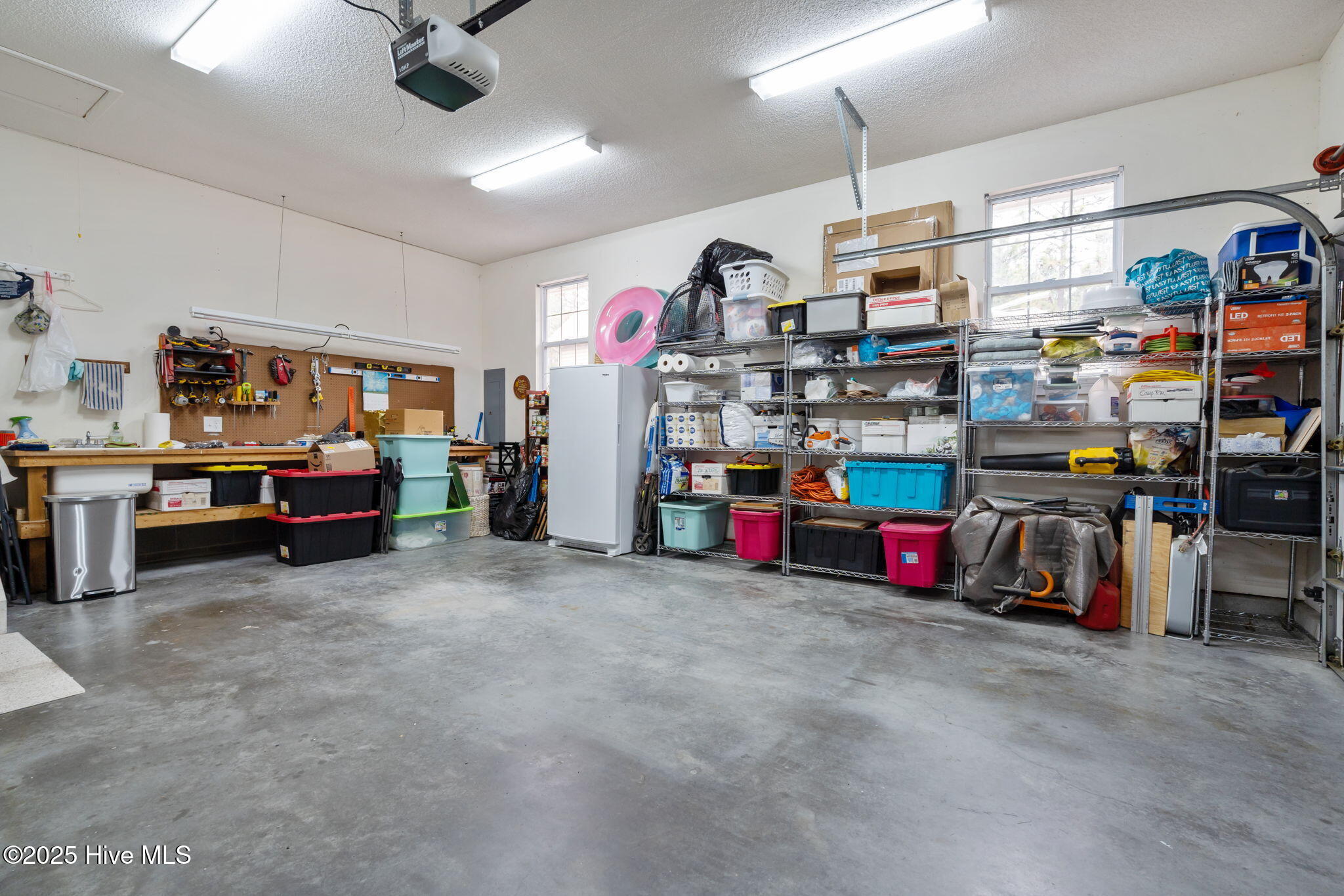 247 Longleaf Drive West End, NC 27376 - Photo 33 of 79 2 Car garage with a great workbench area.