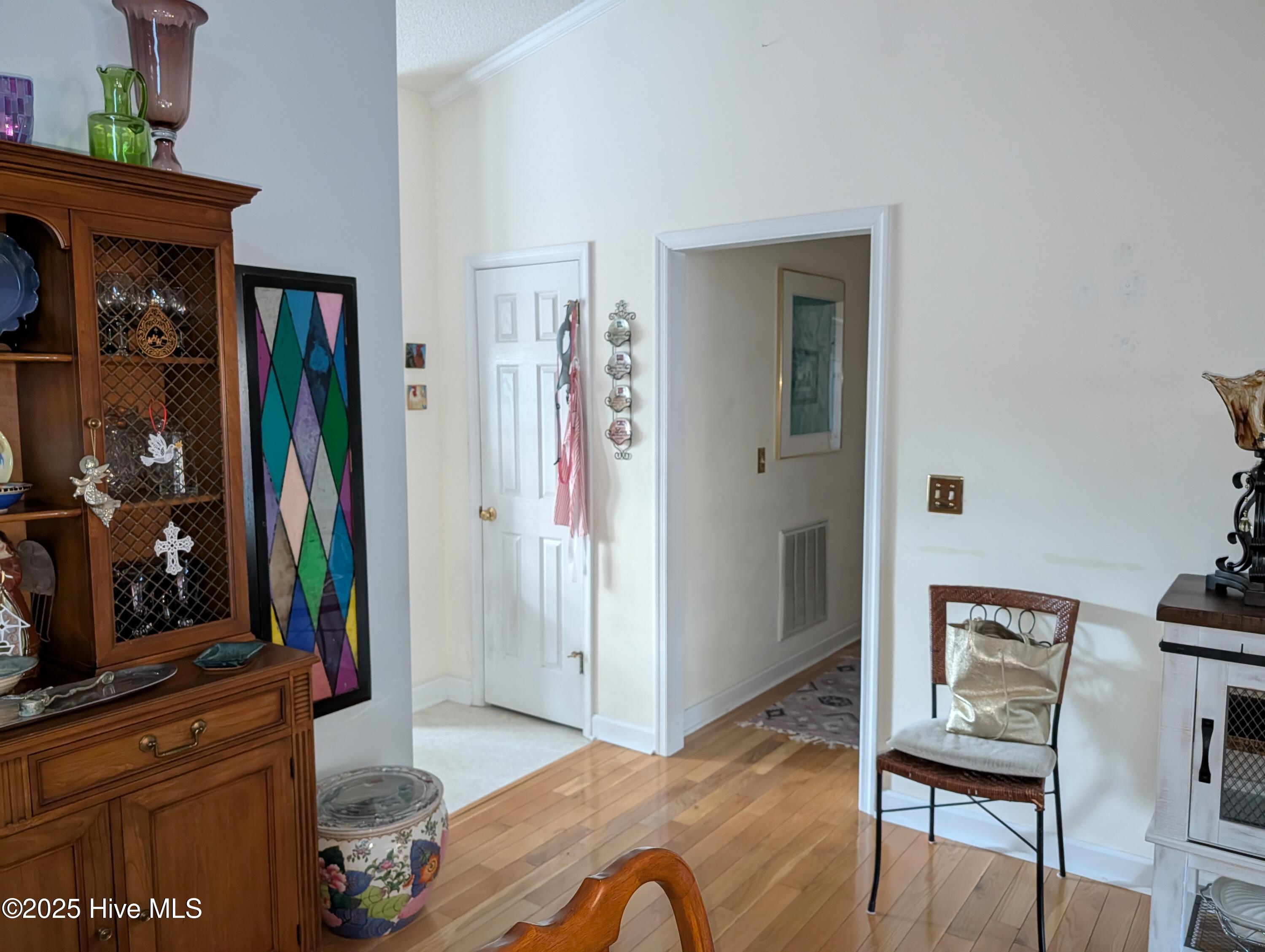 247 Longleaf Drive West End, NC 27376 - Photo 10 of 79 View from the dining room leading to the kitchen and the hallway to the primary bedroom.