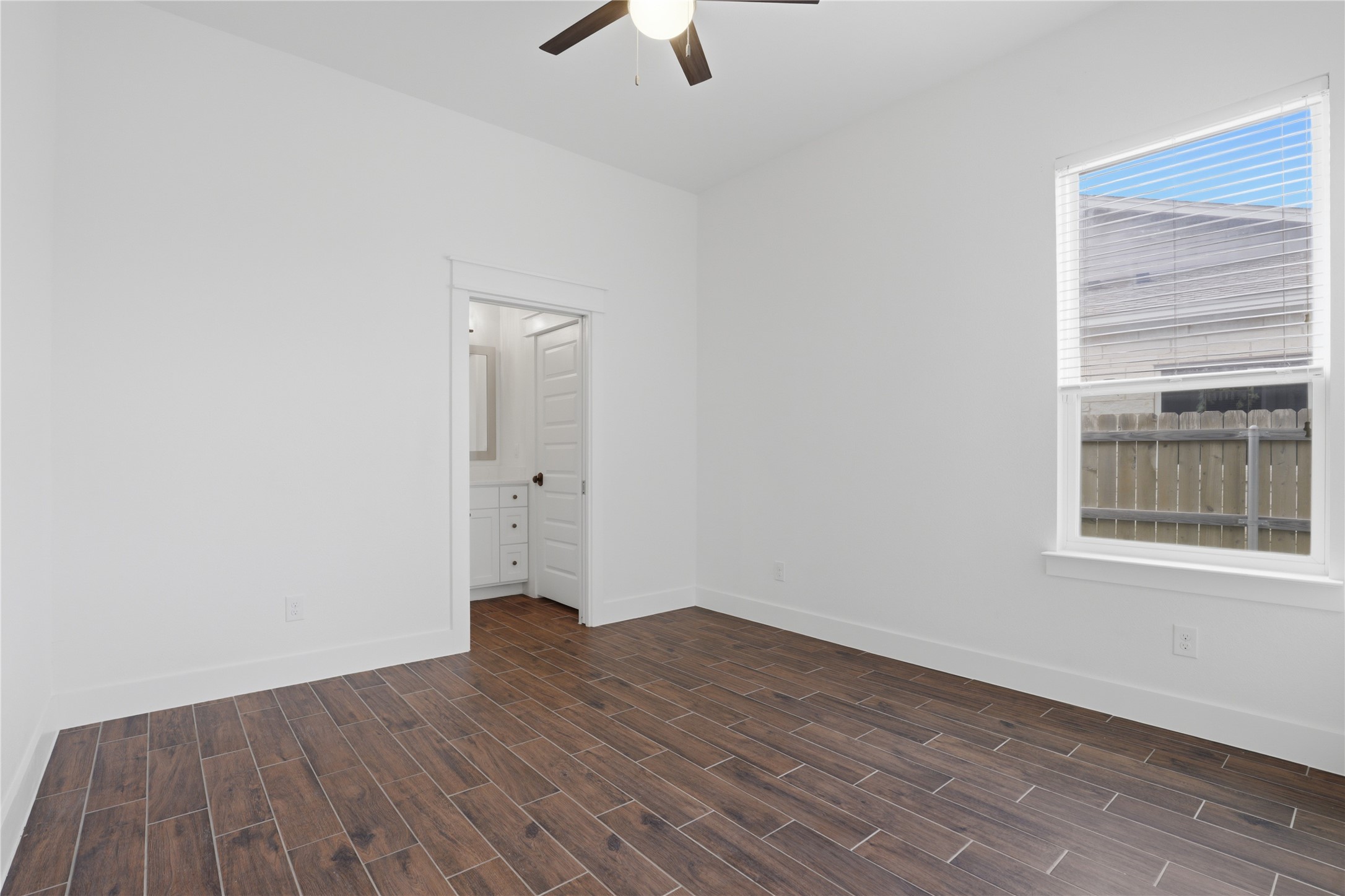 133 Greg Lane Jarrell, TX 76537 - Photo 19 of 24 Bedroom featuring wood-finish tile flooring, white walls and trim, and a ceiling fan with integrated lighting