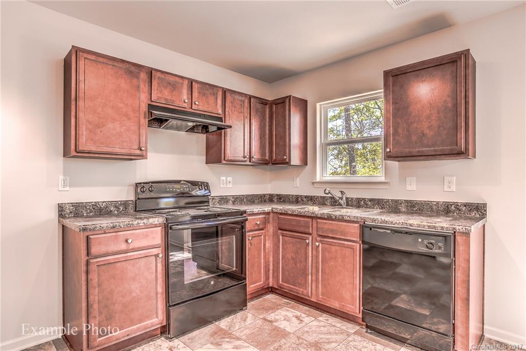2155 Gunnars Ridge Road, Unit 23 Lancaster, SC 29720 - Photo 9 of 24 a kitchen with stainless steel appliances granite countertop a stove sink and cabinets