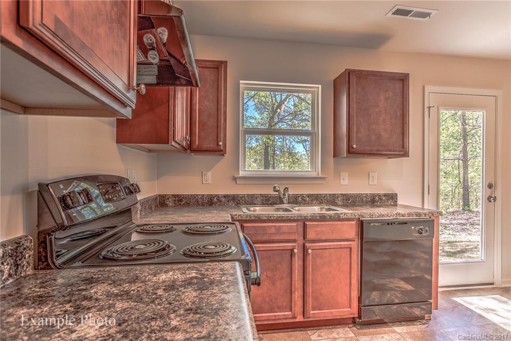 2155 Gunnars Ridge Road, Unit 23 Lancaster, SC 29720 - Photo 10 of 24 a kitchen with granite countertop a sink stove and cabinets