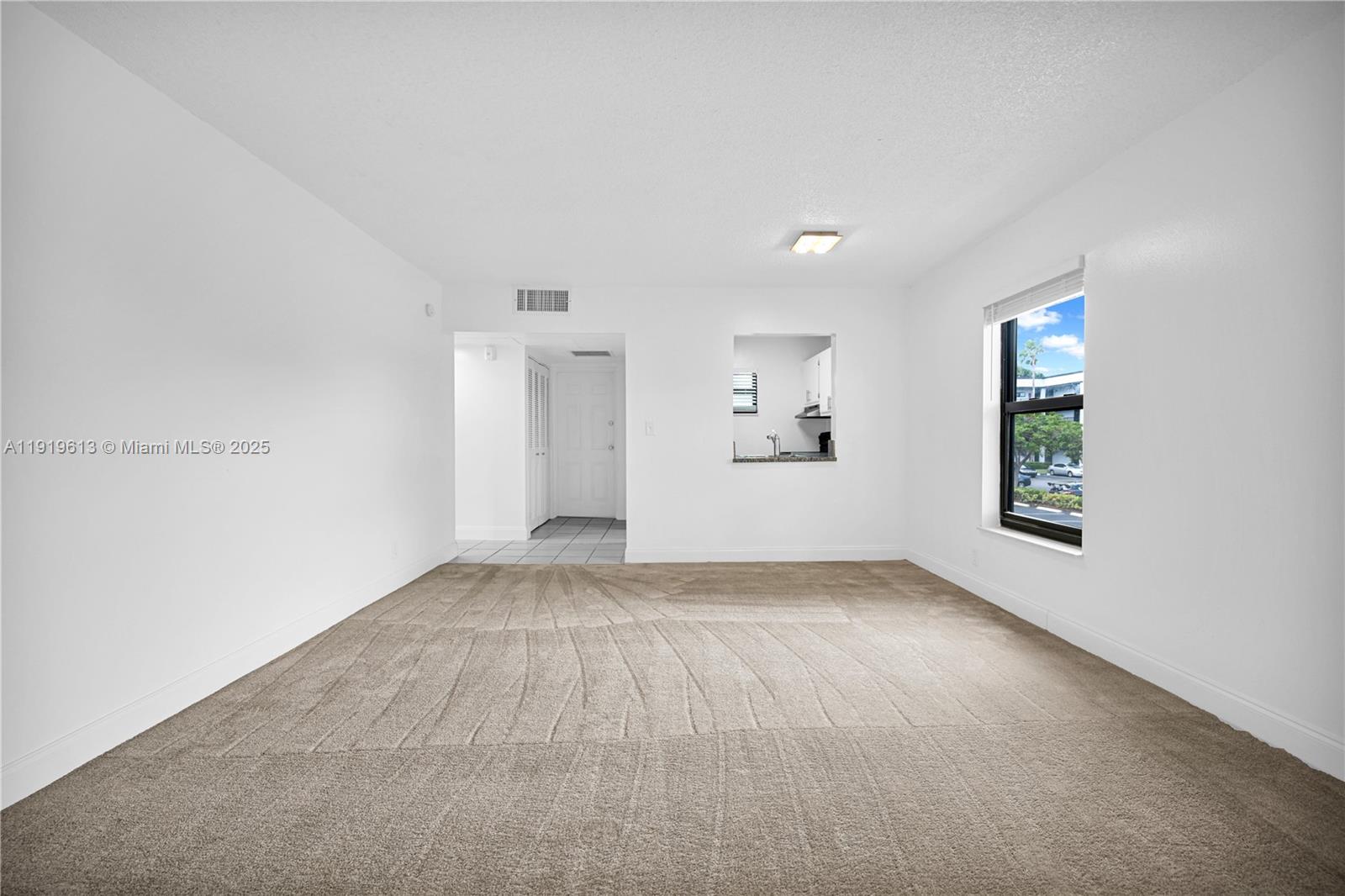 7550 Stirling Road, Unit A107 Davie, FL 33024 - Photo 4 of 27 an empty room with windows