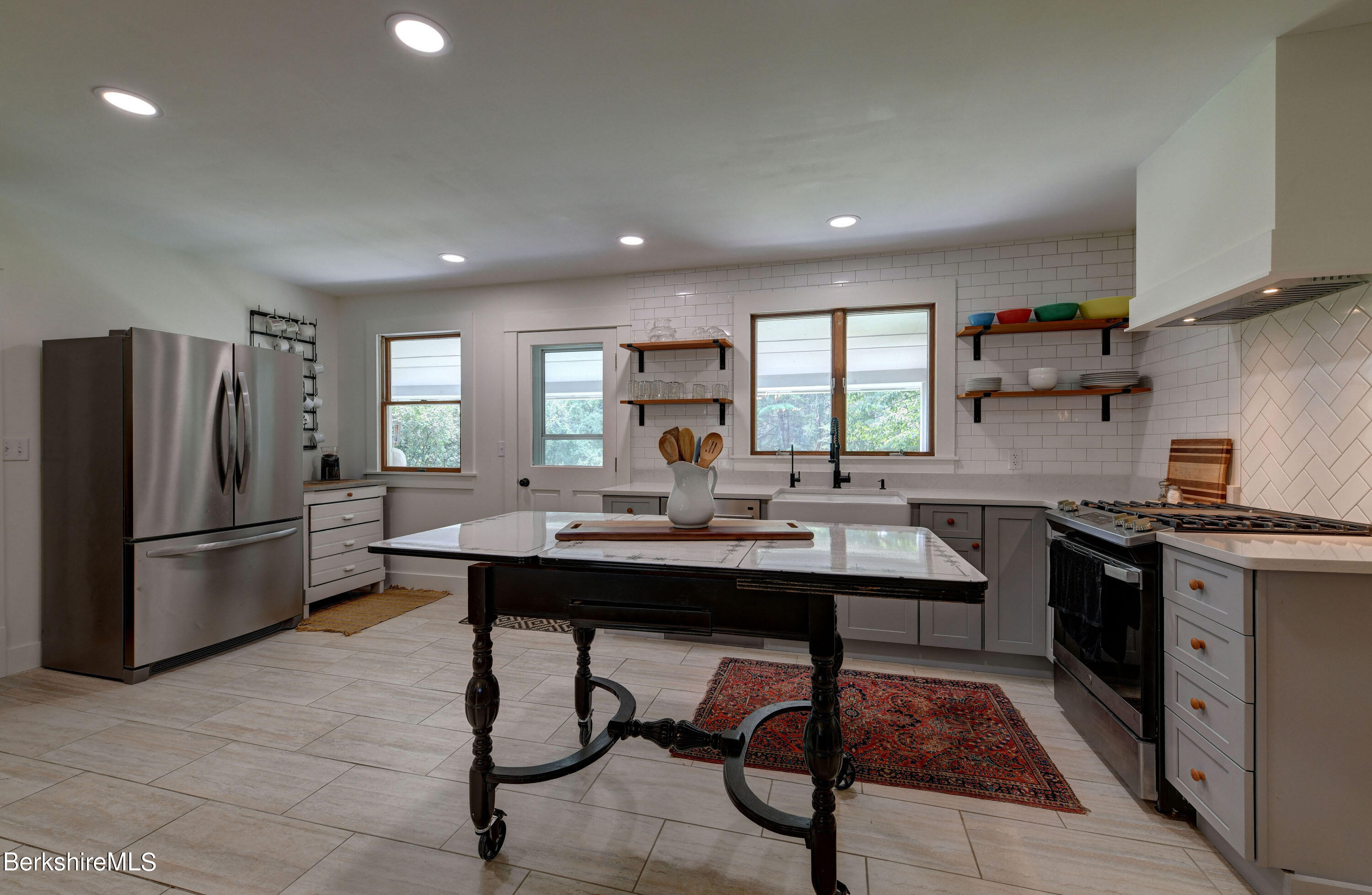 465 Devon Road Lee, MA 01238 - Photo 11 of 36 a kitchen with stainless steel appliances kitchen island granite countertop a sink a stove a refrigerator and cabinets