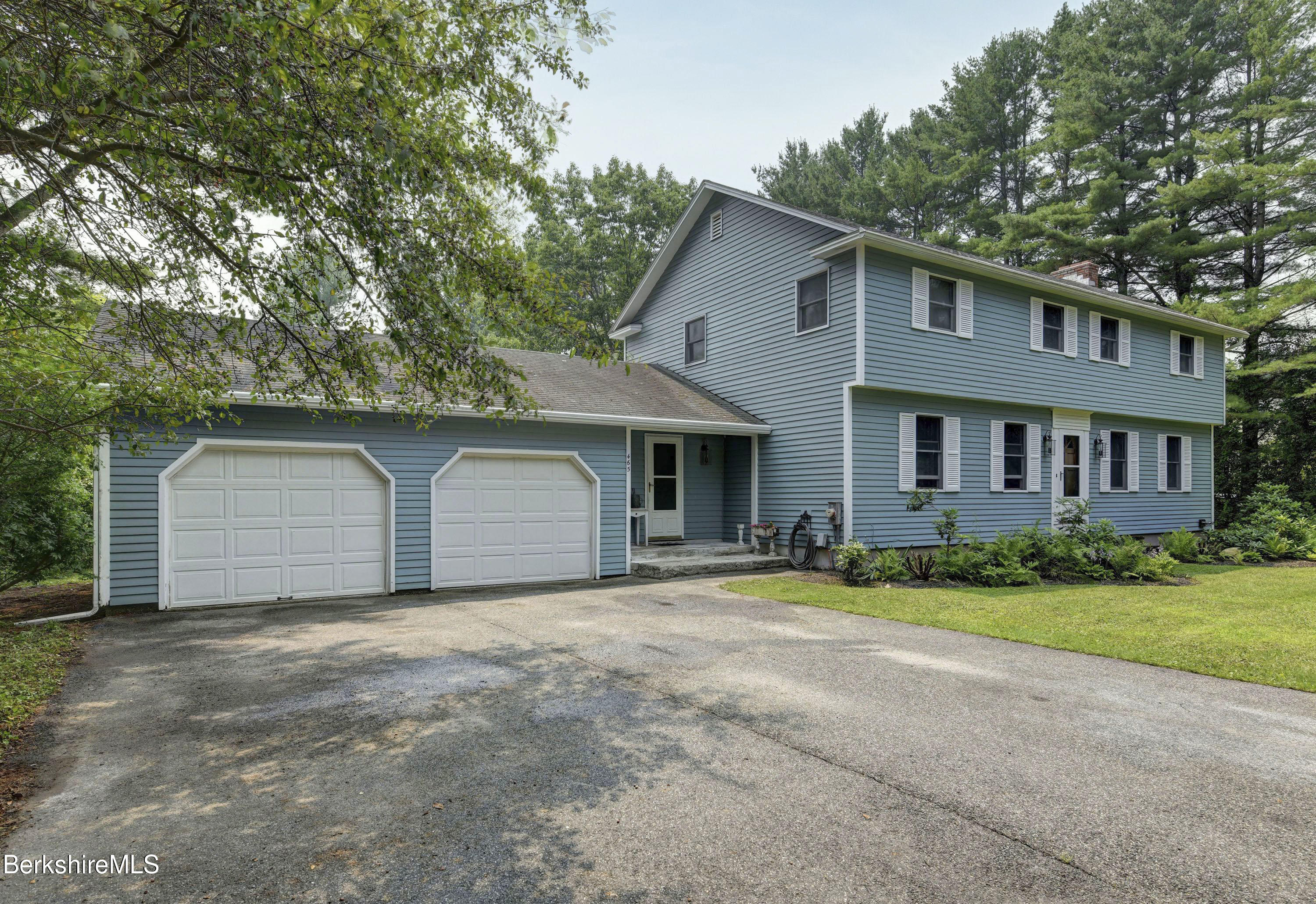 465 Devon Road Lee, MA 01238 - Photo 3 of 36 a front view of a house with a garden and yard