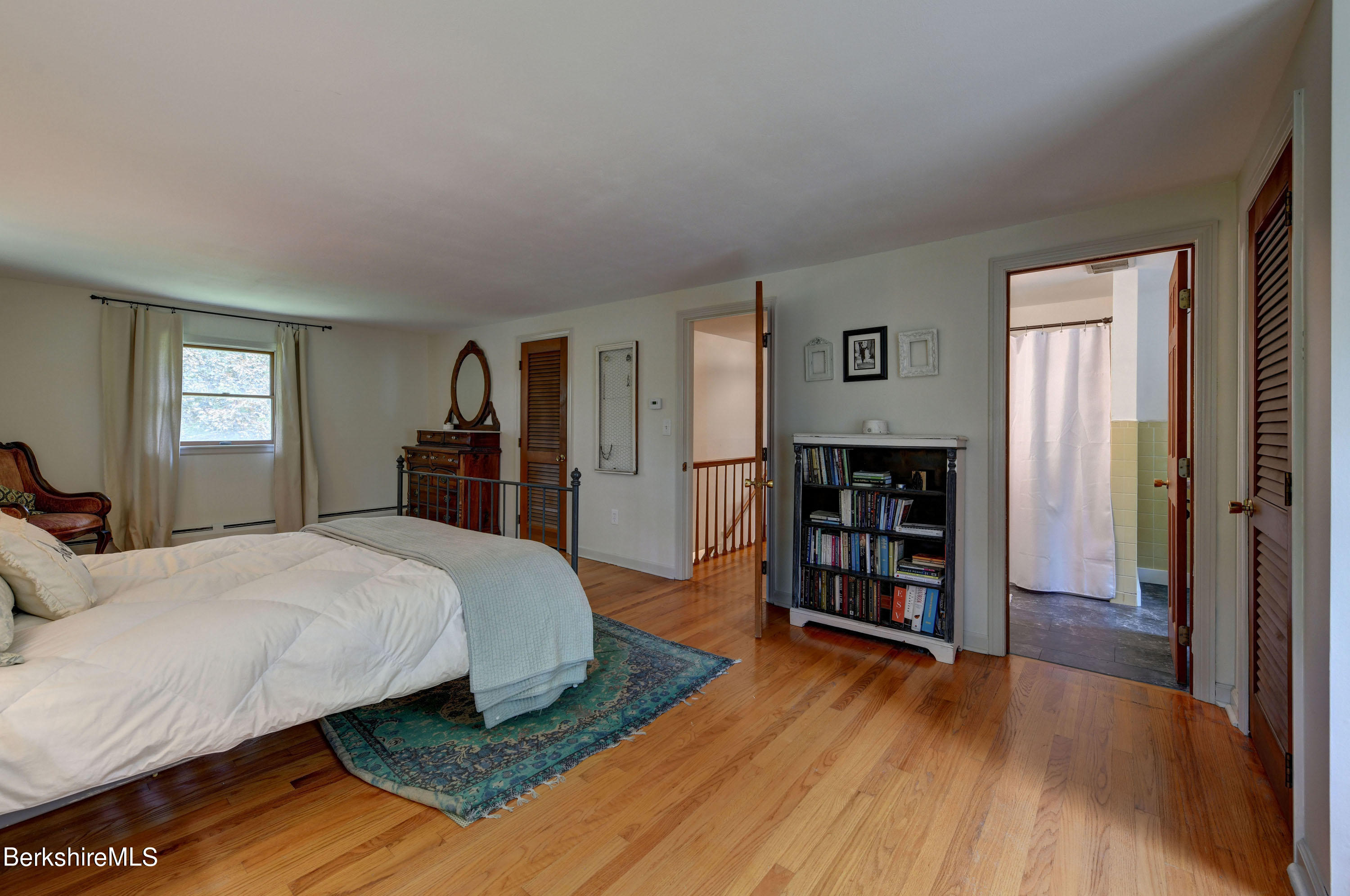 465 Devon Road Lee, MA 01238 - Photo 23 of 36 a spacious bedroom with a bed and a wooden floor
