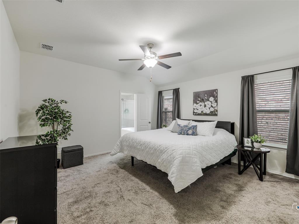 4517 Ashmark Road Aubrey, TX 76227 - Photo 10 of 26 a bedroom with a bed and a potted plant