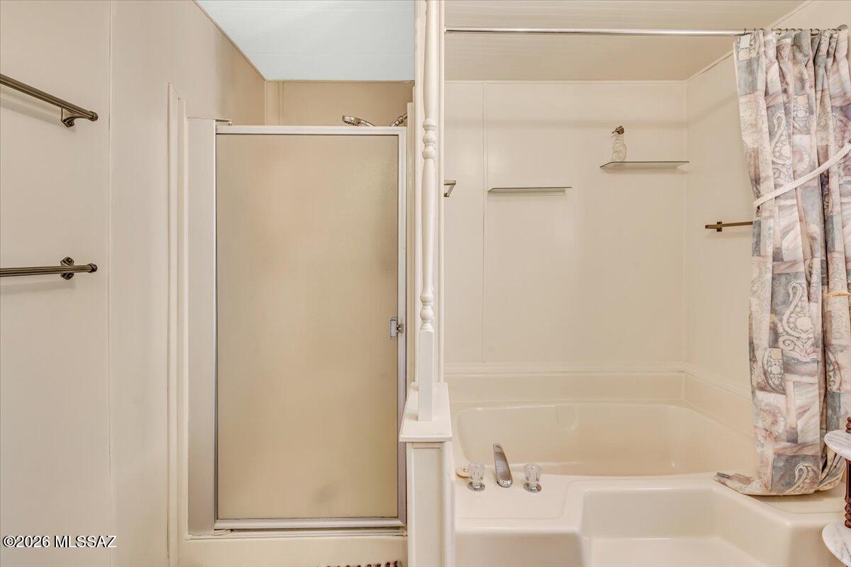 5840 West Flying W Street Tucson, AZ 85713 - Photo 21 of 38 a bathroom with a bathtub and a shower