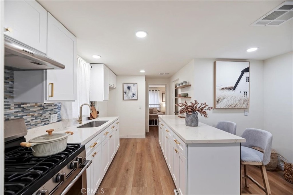 a kitchen with a sink stove and cabinets