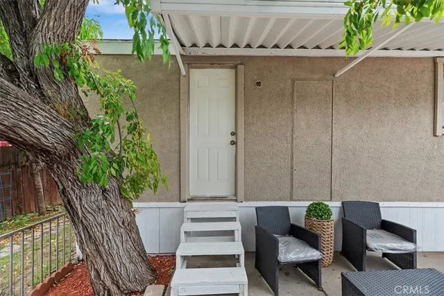 a balcony with furniture and a potted plant