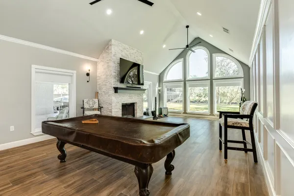 a living room with furniture a table and large windows