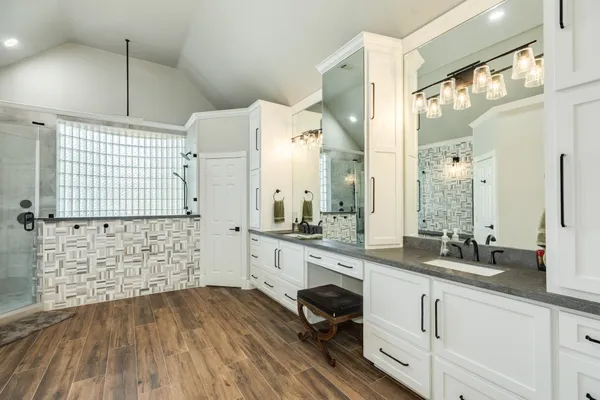 a large white kitchen with a sink and cabinets