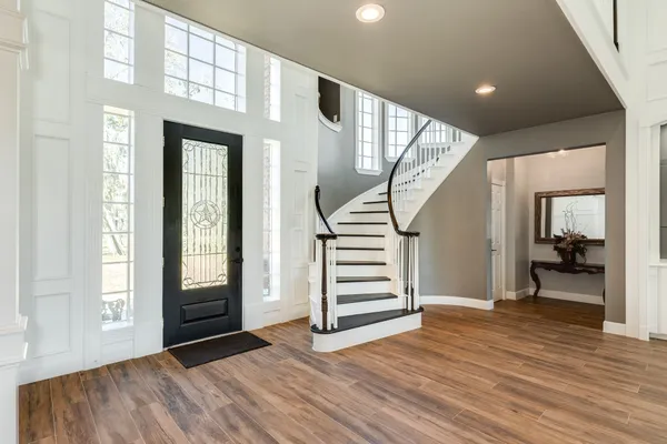 a view of entryway with wooden floor and stairs