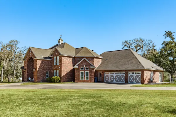an aerial view of a house with a yard basket ball court and outdoor seating