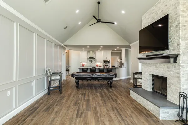 a living room with furniture a fireplace and a flat screen tv