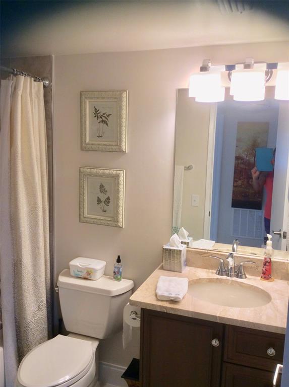 Undisclosed Address Pompano Beach, FL 33069 - Photo 12 of 23 a bathroom with a toilet a sink and a mirror