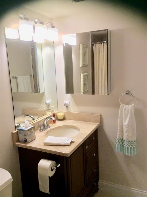 Undisclosed Address Pompano Beach, FL 33069 - Photo 13 of 23 a bathroom with a sink and a mirror