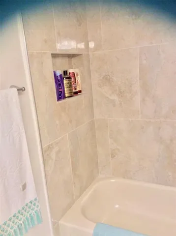 a large bed sitting in a bedroom next to a lamp