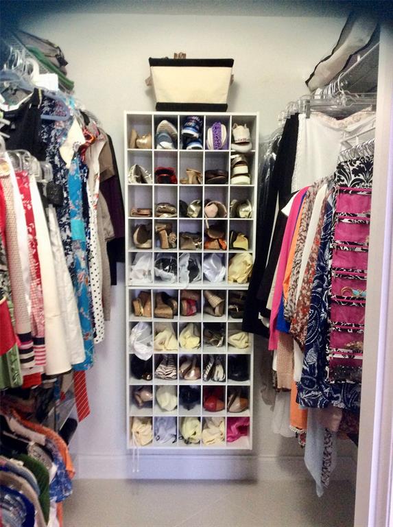 Undisclosed Address Pompano Beach, FL 33069 - Photo 21 of 23 a view of walk in closet with clothes and shoes