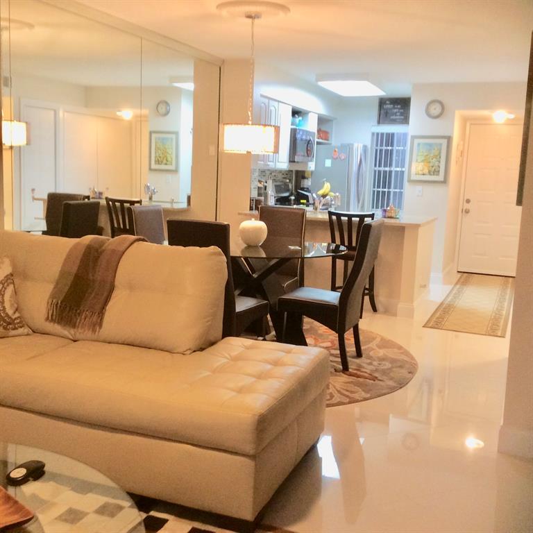 Undisclosed Address Pompano Beach, FL 33069 - Photo 4 of 23 a living room with a couch and a potted plant