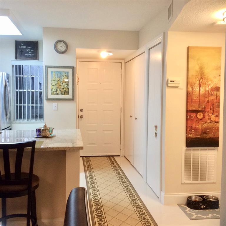 Undisclosed Address Pompano Beach, FL 33069 - Photo 5 of 23 a view of a hallway to a livingroom with furniture and window
